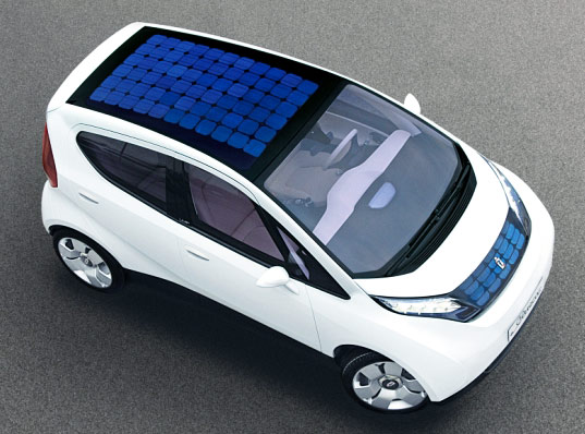 White electric car with solar panels on the roof.