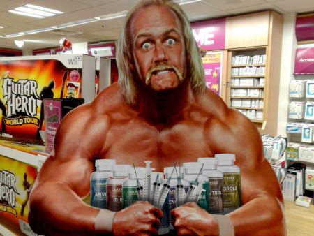 Cardboard cutout of muscular man in store.