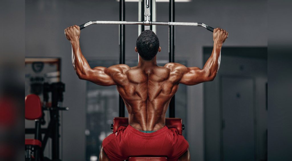 Man doing a lat pulldown at gym.