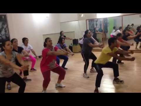 People exercising in a fitness class room.